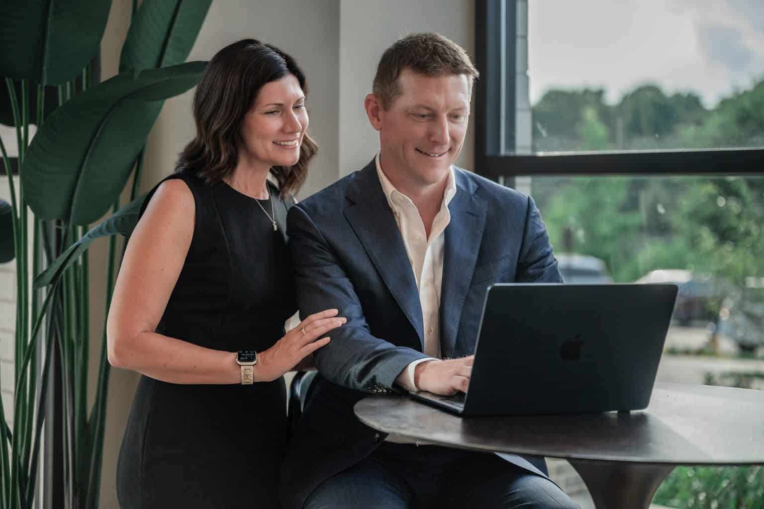 RL Hesson and his wife looking over a laptop together