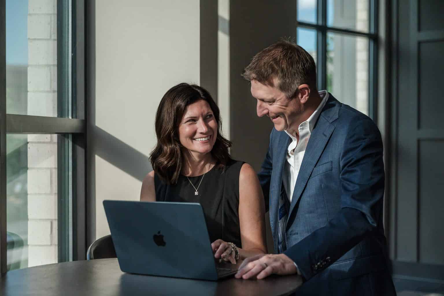 RL Hesson and his wife reviewing numbers on a laptop